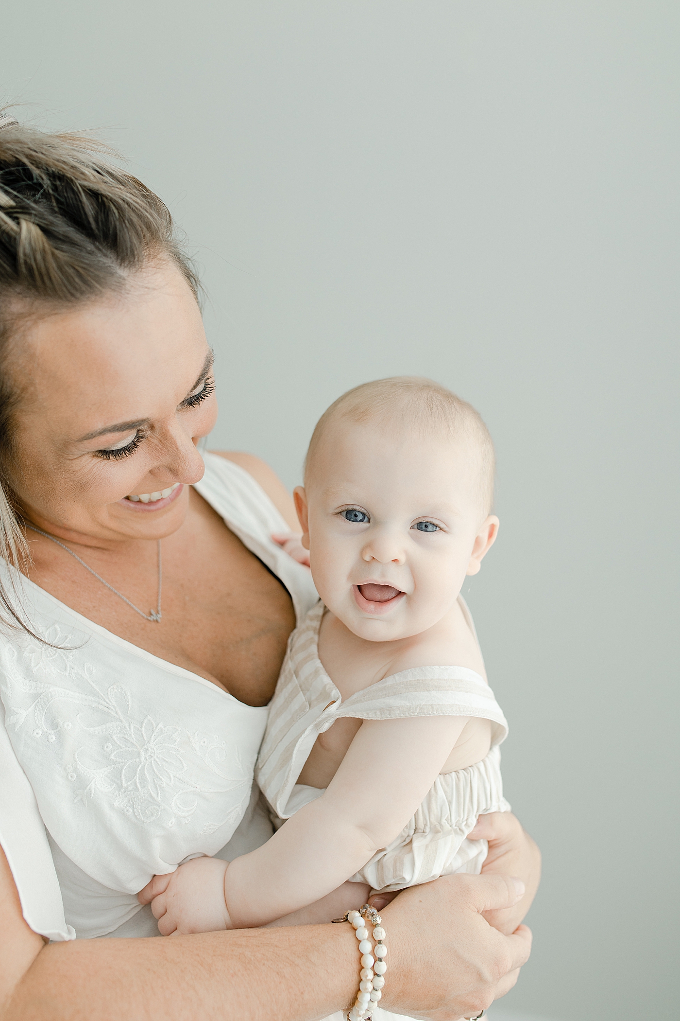 Baby boy and mom smiling | Photo by Little Sunshine Photography
