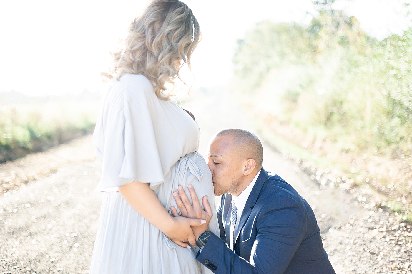 Dad to be kissing mom's belly | Photo by Little Sunshine Photography 