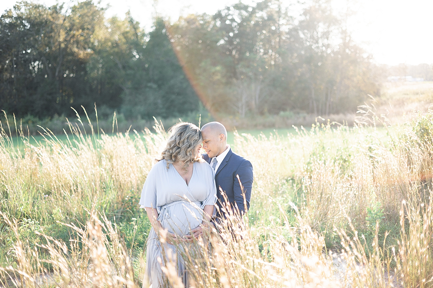 Mom and dad to be in a golden field | Photo by Gulfport MS Maternity and Newborn Photographer Little Sunshine Photography 