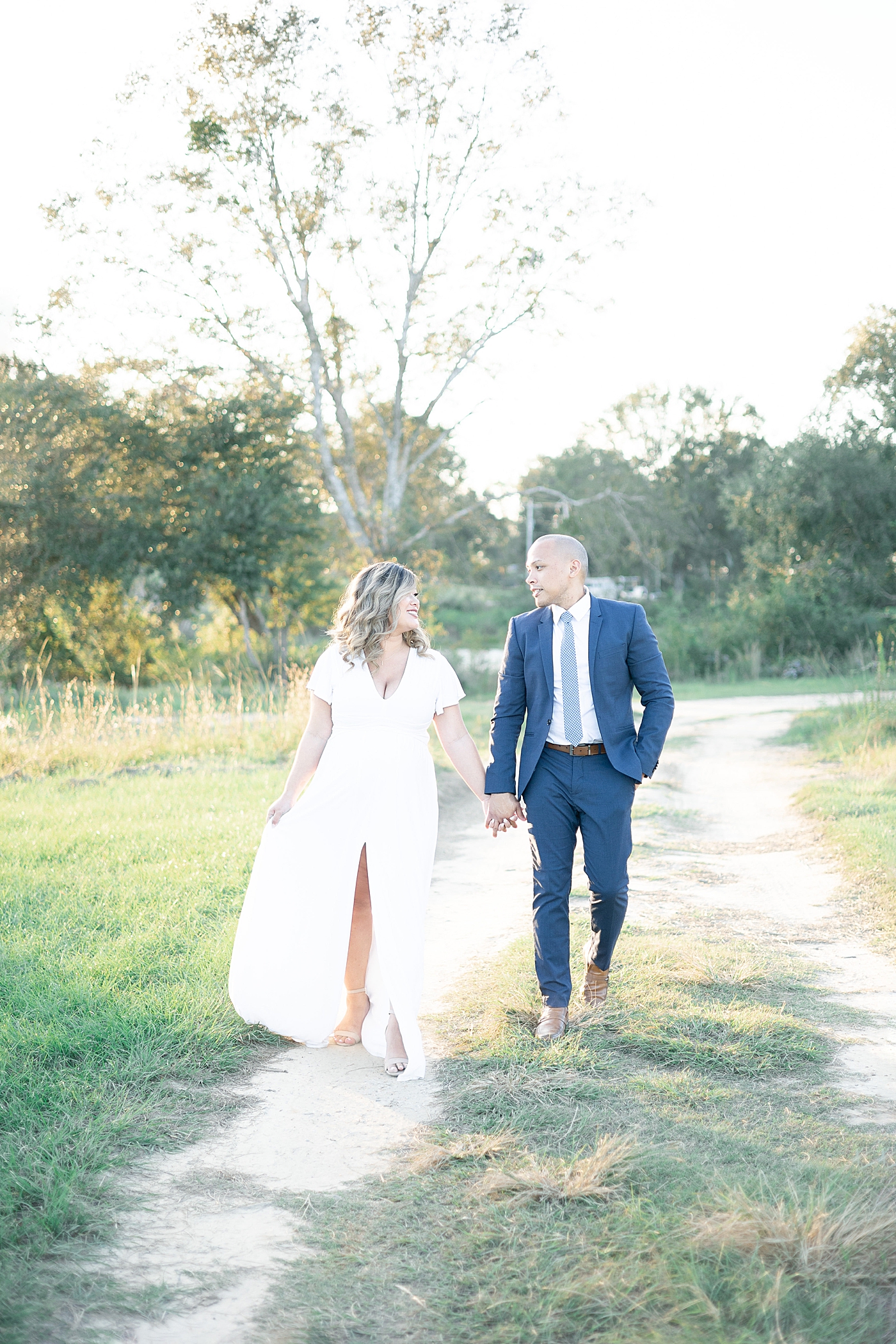 Mom and dad to be walking a dirt path | Photo by Gulfport MS Maternity and Newborn Photographer Little Sunshine Photography 