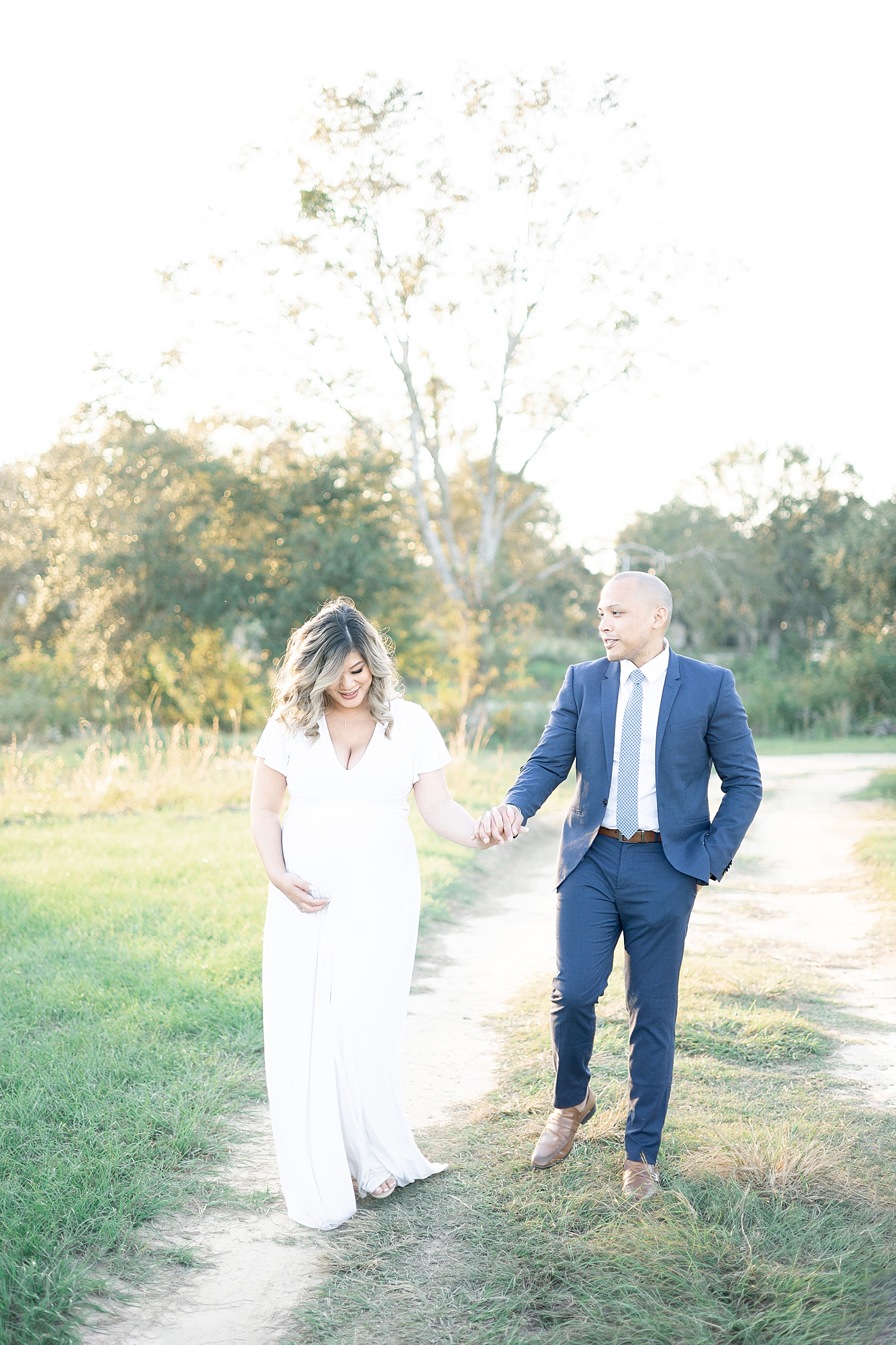 Mom and dad to be walking a dirt path | Photo by Gulfport MS Maternity and Newborn Photographer Little Sunshine Photography 