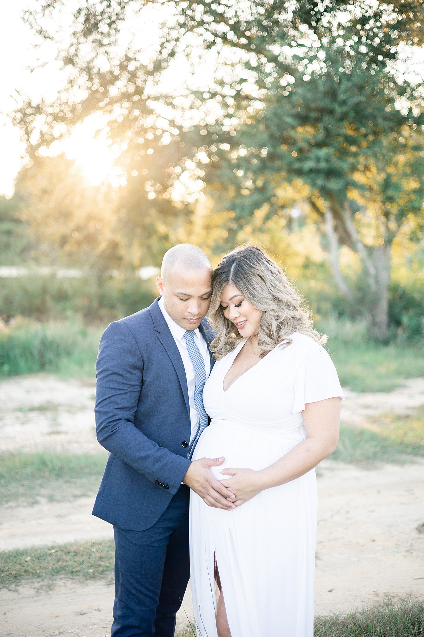 Mom and dad to be cradling her belly | Photo by Gulfport MS Maternity and Newborn Photographer Little Sunshine Photography 