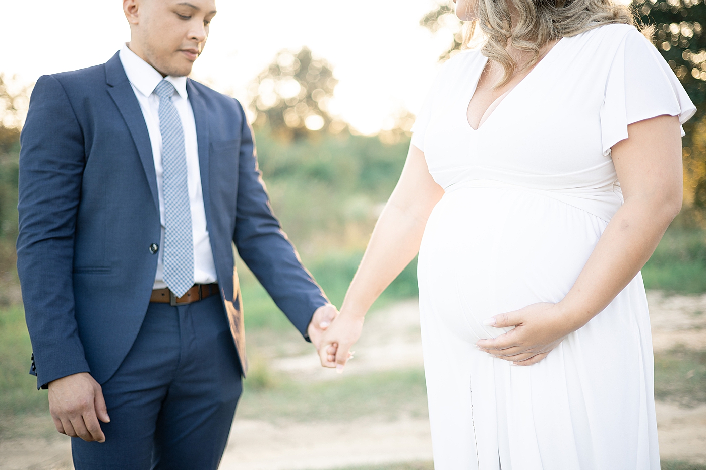 Mom and dad to be holding hands | Photo by Little Sunshine Photography 