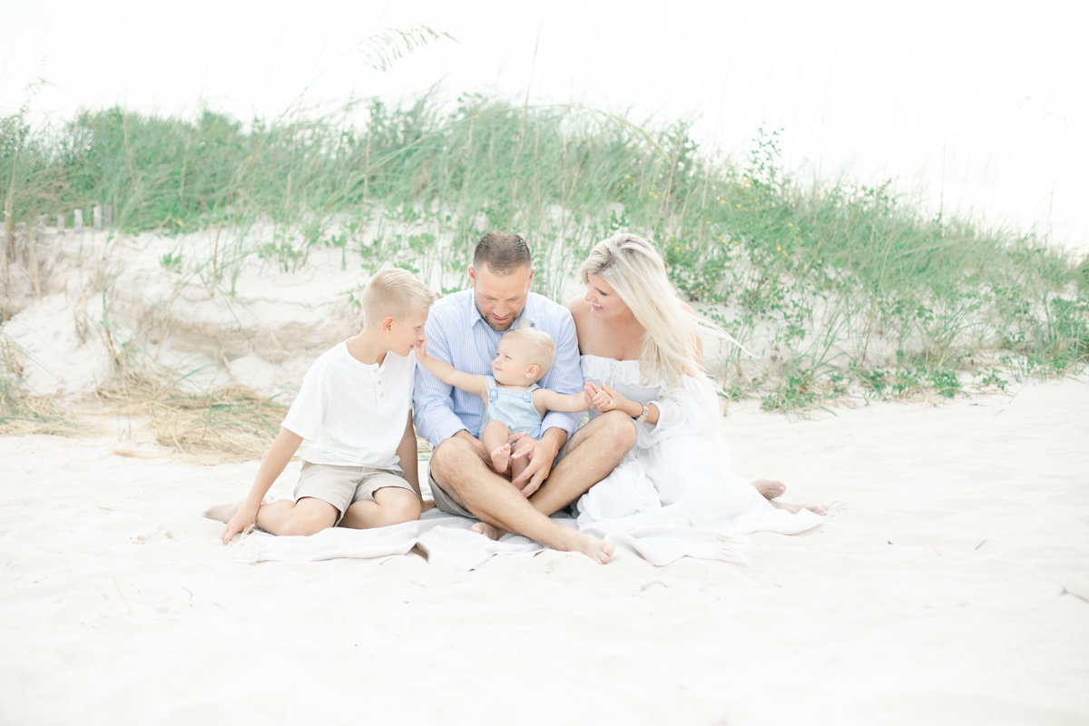 baby boy and family sitting on beach MS Gulf Coast